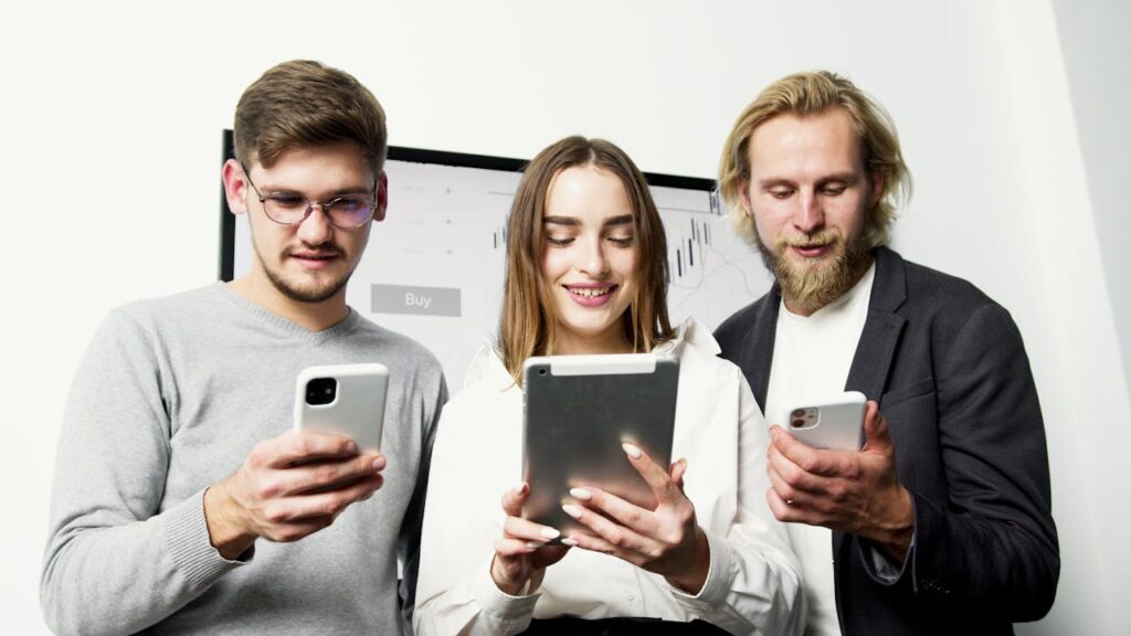 pexels photo 5716044 Three professionals using digital devices for financial analysis in an office setting.